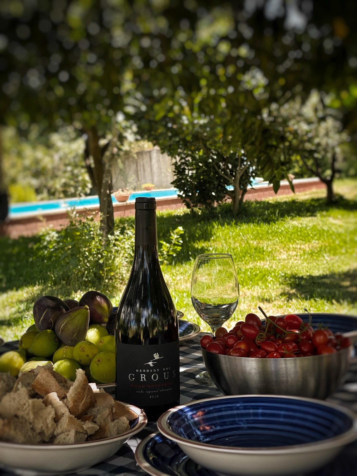 Outdoor table with bread and local produce