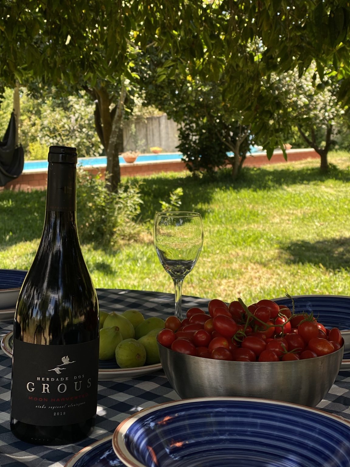 Portuguese table with tomatoes, figs and wine glasses